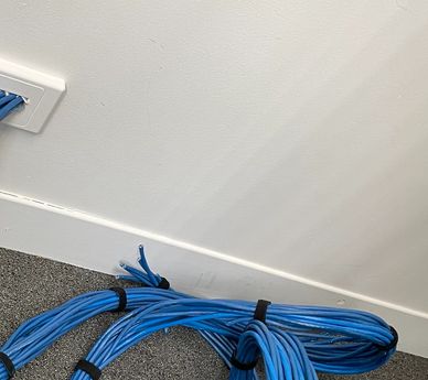 Work in progress installing CAT6 blue data cable in an office building.