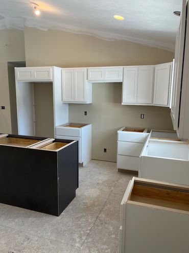 New Home with White Kitchen Cabinets and Large Island. Remodel and Renovations.
