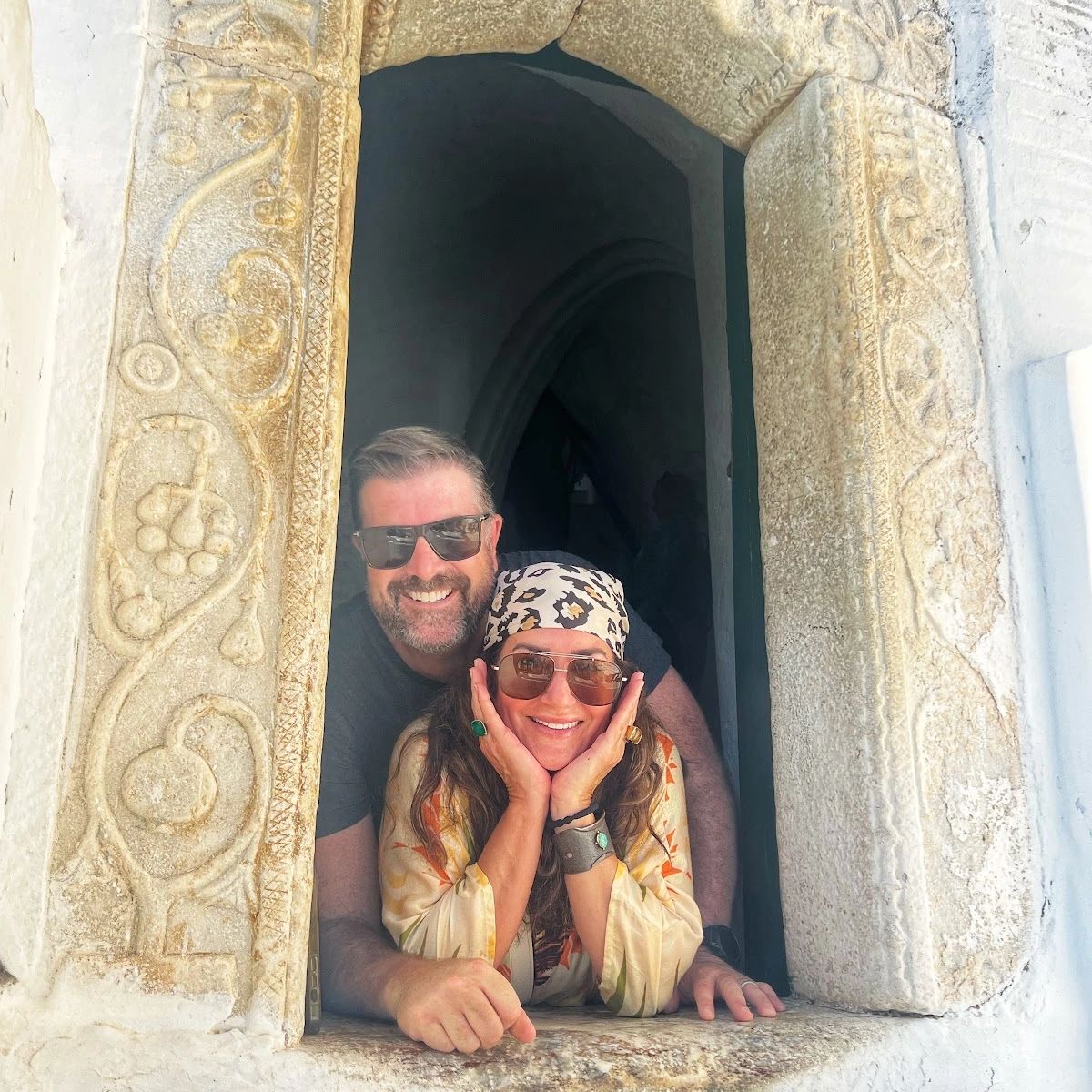 Two men wearing sunglasses and looking ahead