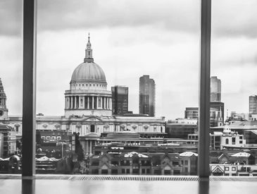 Black and white cityscape featuring St. Paul's Cathedral through a window.