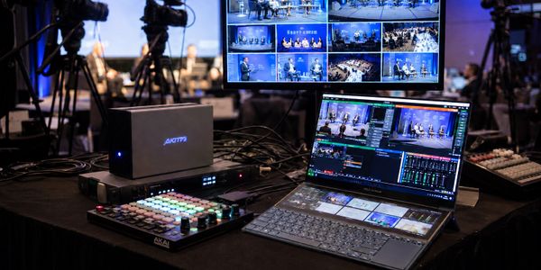 Video production setup with multiple screens and control panels.