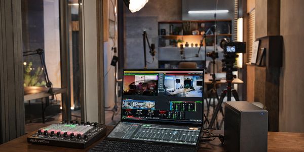 A professional video editing and streaming setup with multiple devices.