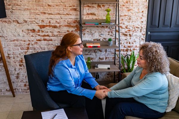 Therapist holding a client's hands