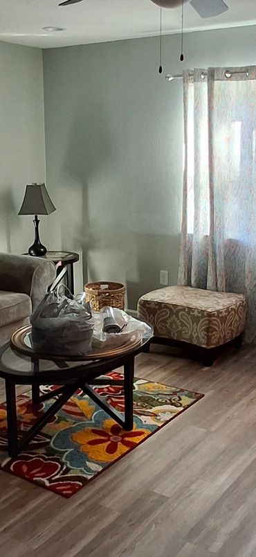 Living room with 60-inch TV, sectional seating up to eight, and throw blankets for added comfort.