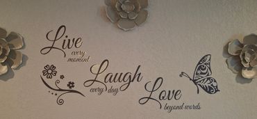 Inspirational wall art with butterfly accents welcoming guests into the living space.