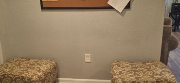 Community area with seating, information board, and access to shared resources.