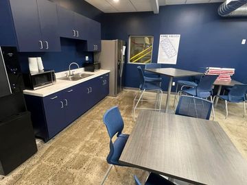 Kitchen with tables and fridge and sink