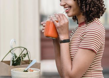 a women eating the drink on the office