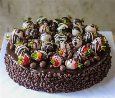 Indulge in our decadent Chocolate Cake, adorned with luscious strawberries and rich chocolate chips.