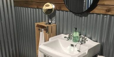 Luxury bathroom facilites shower, basin and flushing toilet
