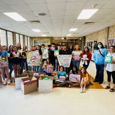 Parenting plus graduates celebrate with signs, boxes and smiles