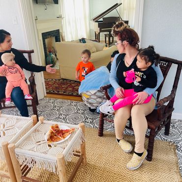 Parenting Plus clients it in a circle with their little ones in an informal support group.