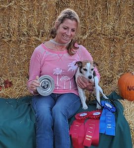 A Woman In A Pink Color Shirt With A Puppy