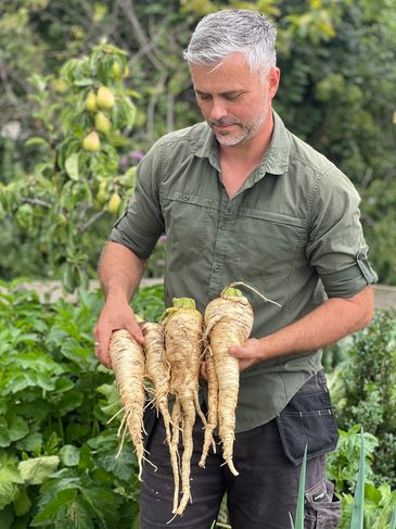Rob holding freshly harvested parsnips!