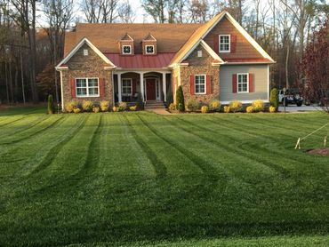 A beautiful house with well-maintained lawn and landscaping.