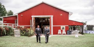 The groom and best man headed to the wedding, walking out of our red barn.