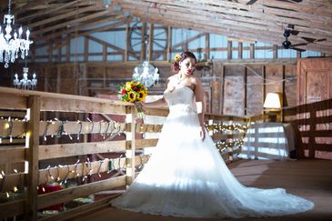 A bride standing upstairs in our barn wedding venue.