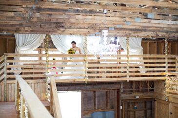A bride in front of our country curtains upstairs in our barn wedding venue.