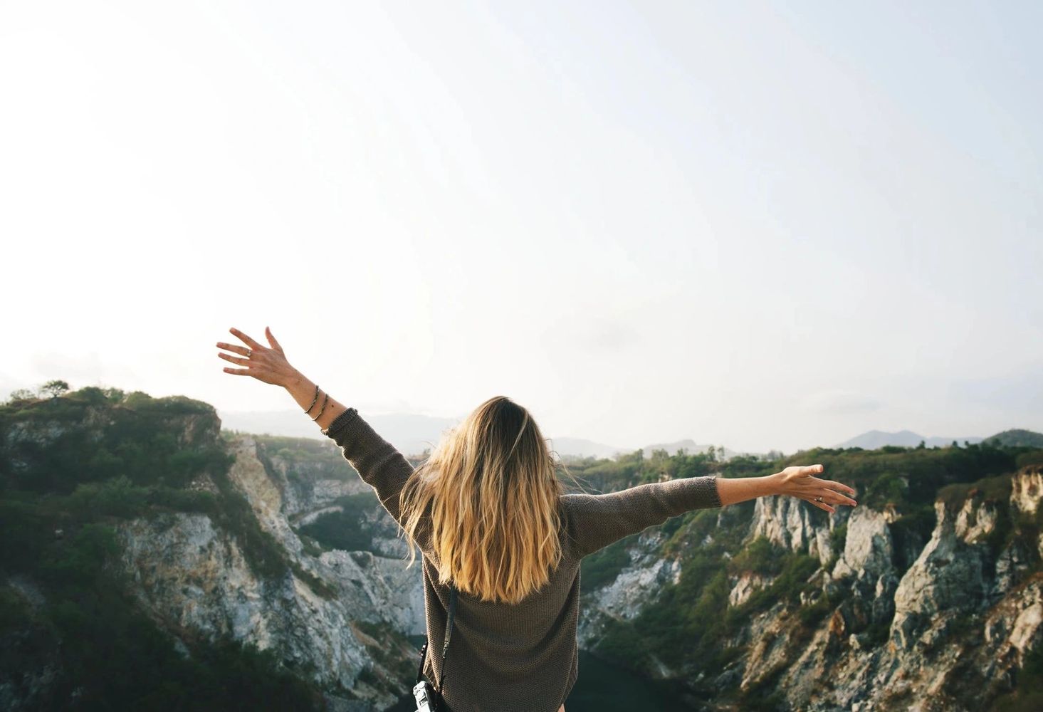 Woman with outstretched hands feeling the benefit of premium quality CBD product from CBD Wellness