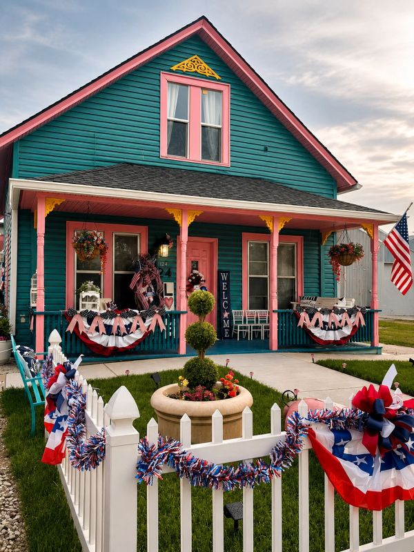 Colorful house with patriotic decorations and an inviting porch.