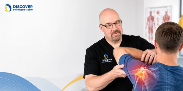 Dr. Lambert evaluating shoulder motion for a patient with recurring shoulder pain in Grand Rapids.