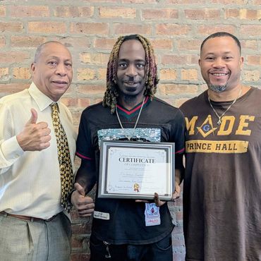three men standing next to each other holding a certificate