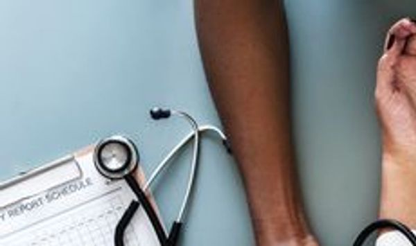 A doctor checks a patient's blood pressure using a sphygmomanometer
