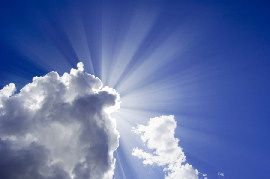 Inspirational photo of a blue sky with sunlight streaming through clouds
