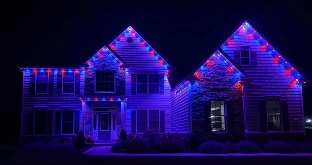 House decorated with blue and red Govee lights at night.