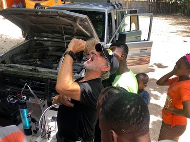 Joe is drinking water from the Rescuer Water Purifier in Haiti.