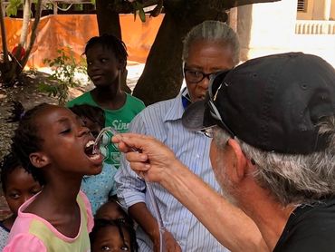 A little girl drinking water from the Air Mobile Rescuer Water Purifier in Haiti