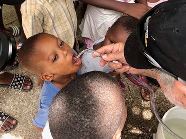 A boy drinking water from the Air Mobile Rescuer Water Purifier in Haiti