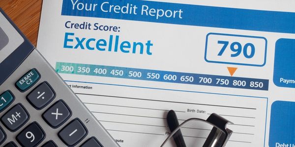 A credit report with a calculator and eye glasses