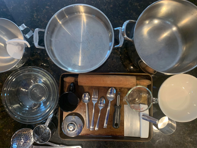 Various kitchen utensils and cookware arranged on a countertop.