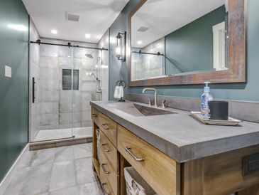 Clean & cool bathroom by Macik Custom Woodworking.