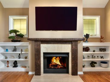 Simple yet sophisticated, timber mantel with built-ins by Macik Custom Woodworking.