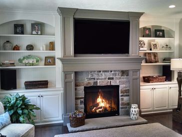 Fireplace mantel and built-ins by Macik Custom Woodworking.