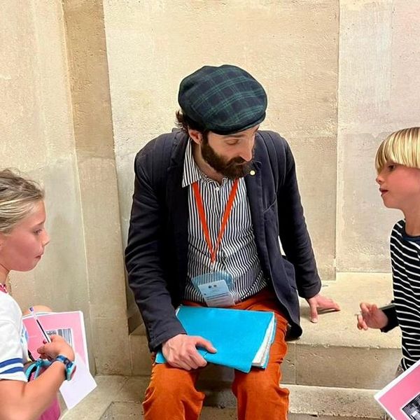 Louvre guide with two kids during treasure hunt in the Louvre
