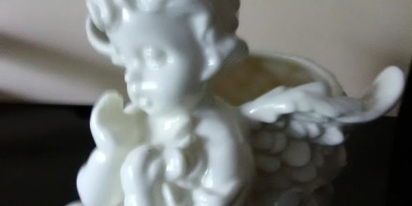 White ceramic angel figurine with wings.