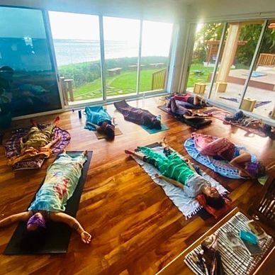 Participants receiving sound healing from Keema at Elizabeth Taylor Estate on Oahu Hawaii