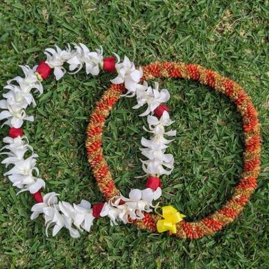 Rev. Keema Cooper Giesselmann showing leis received from recently married couple