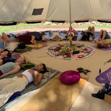 Participants in tent resting during sound vibrational healing by KeemaTherapy on North Shore Oahu