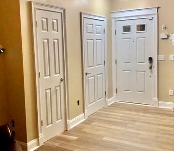 “Interior Door Renovation”3 enlarged doors, w/ larger baseboards installed and new door casing.