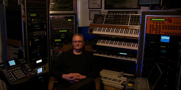 Mark V Sheldon online music teacher in music production studio with synthesizers and Pro Tools