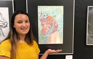 Arianna art displayed in art show case.