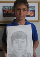 Sasha completed his pencil drawing of himself.