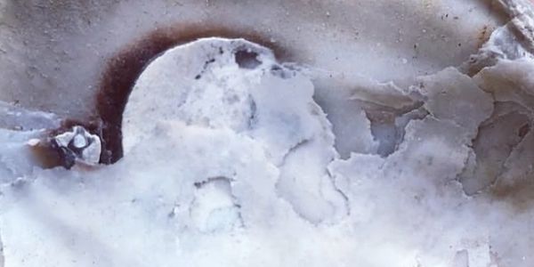 Close-up of a white and light purple marbled stone surface.
