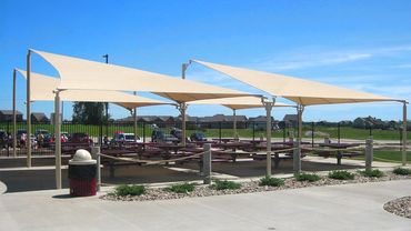 Shade sails over picnic area.