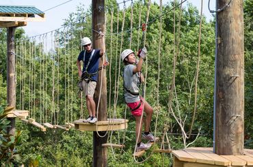 Michigan students participating in High Ropes Course program.