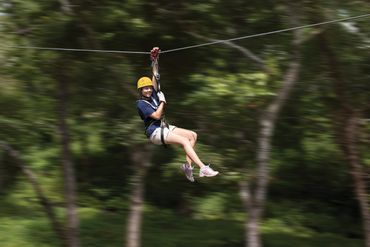 Summer camp participant on zip line in Ohio.